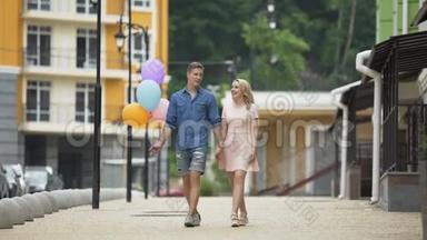 男的拿着气球，女的在街上闲逛，聊天，浪漫的约会